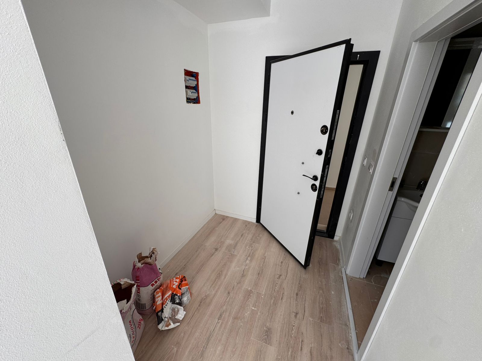 Bright, empty room with modern wood flooring, open layout, bathroom access&mdash;ideal Ulcinj investment via montenegro-listings.me by ekosphere doo.