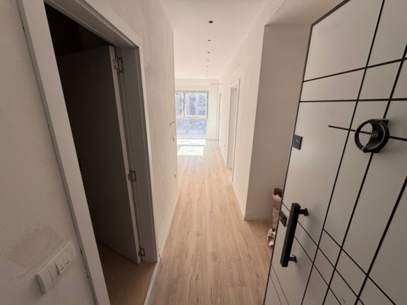 Modern hallway in Ulcinj property with light wood floors, white walls, and bright windows&mdash;exclusive via montenegro-listings.me, by ekosphere doo.