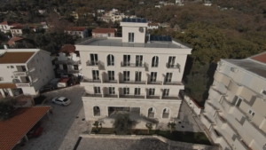 Premium four-story residence in Ulcinj with balconies, solar panels, stone facade; ideal investment by Ekosphere doo—montenegro-listings.me.