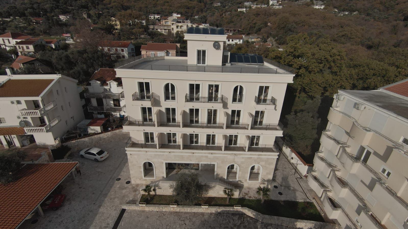 Premium four-story residence in Ulcinj with balconies, solar panels, stone facade; ideal investment by Ekosphere doo&mdash;montenegro-listings.me.