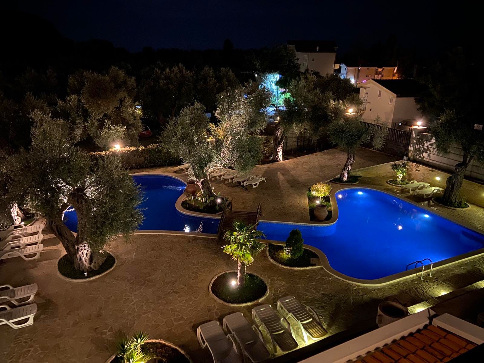 Stunning Ulcinj property: well-lit twin pools, lush gardens, and modern lounges&mdash;prime Montenegro real estate on montenegro-listings.me.