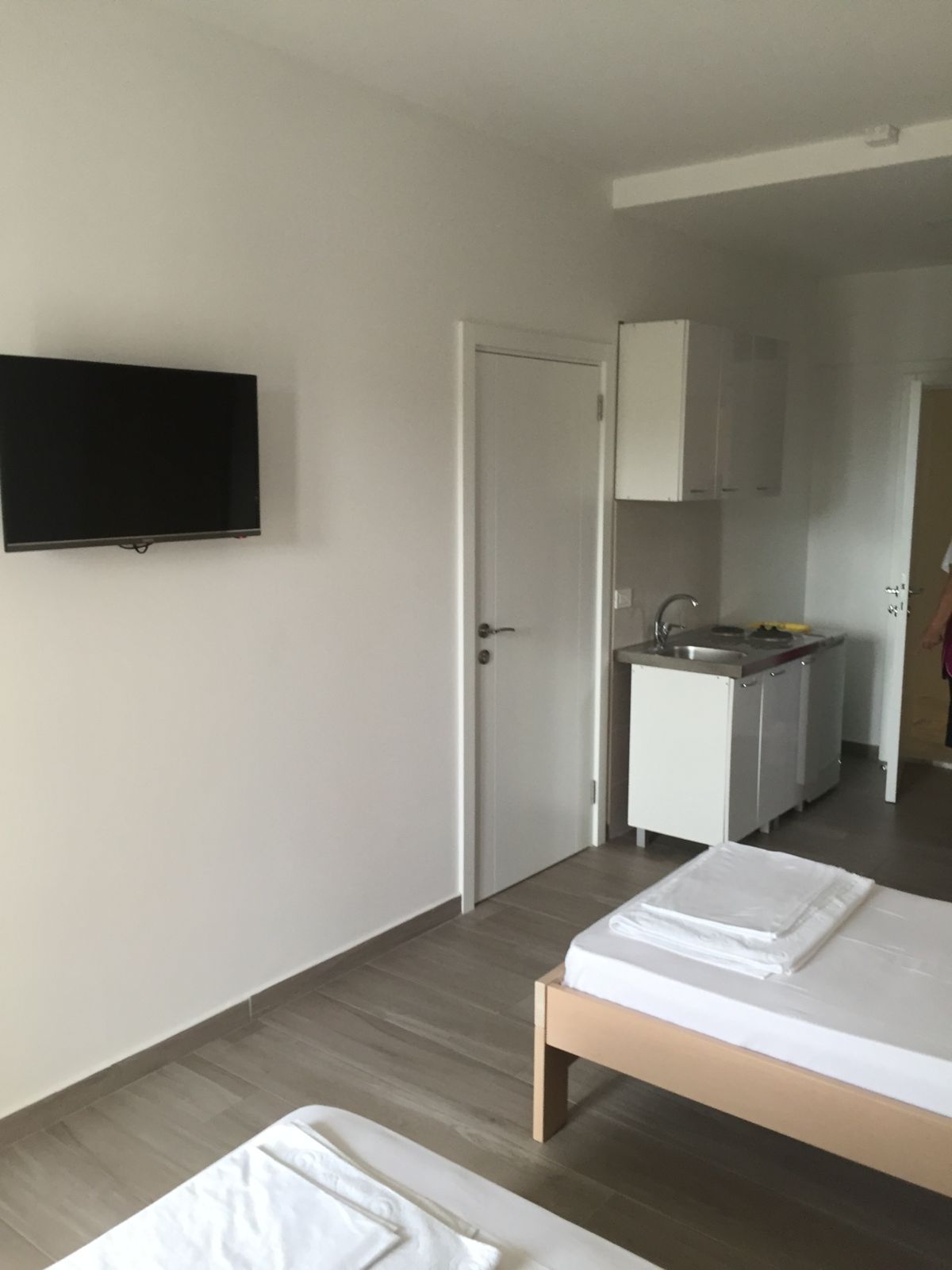 Modern, minimalist Ulcinj studio with two beds, kitchenette, TV. Bright decor. Ideal Montenegro investment via ekosphere doo project.