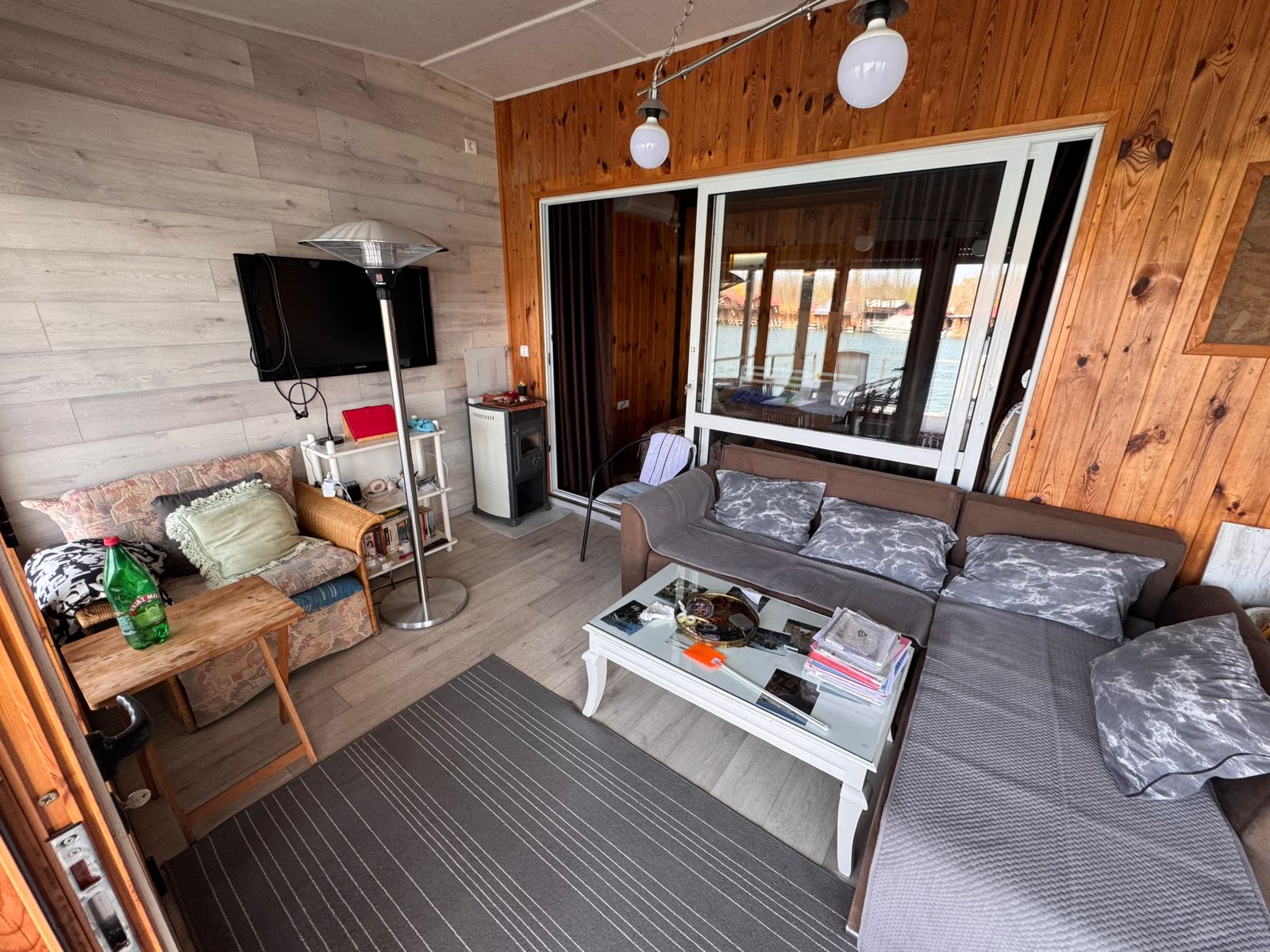 Stylish Ulcinj living room: wood and gray walls, L-shaped sofa, modern decor&mdash;exclusive at montenegro-listings.me by ekosphere doo.