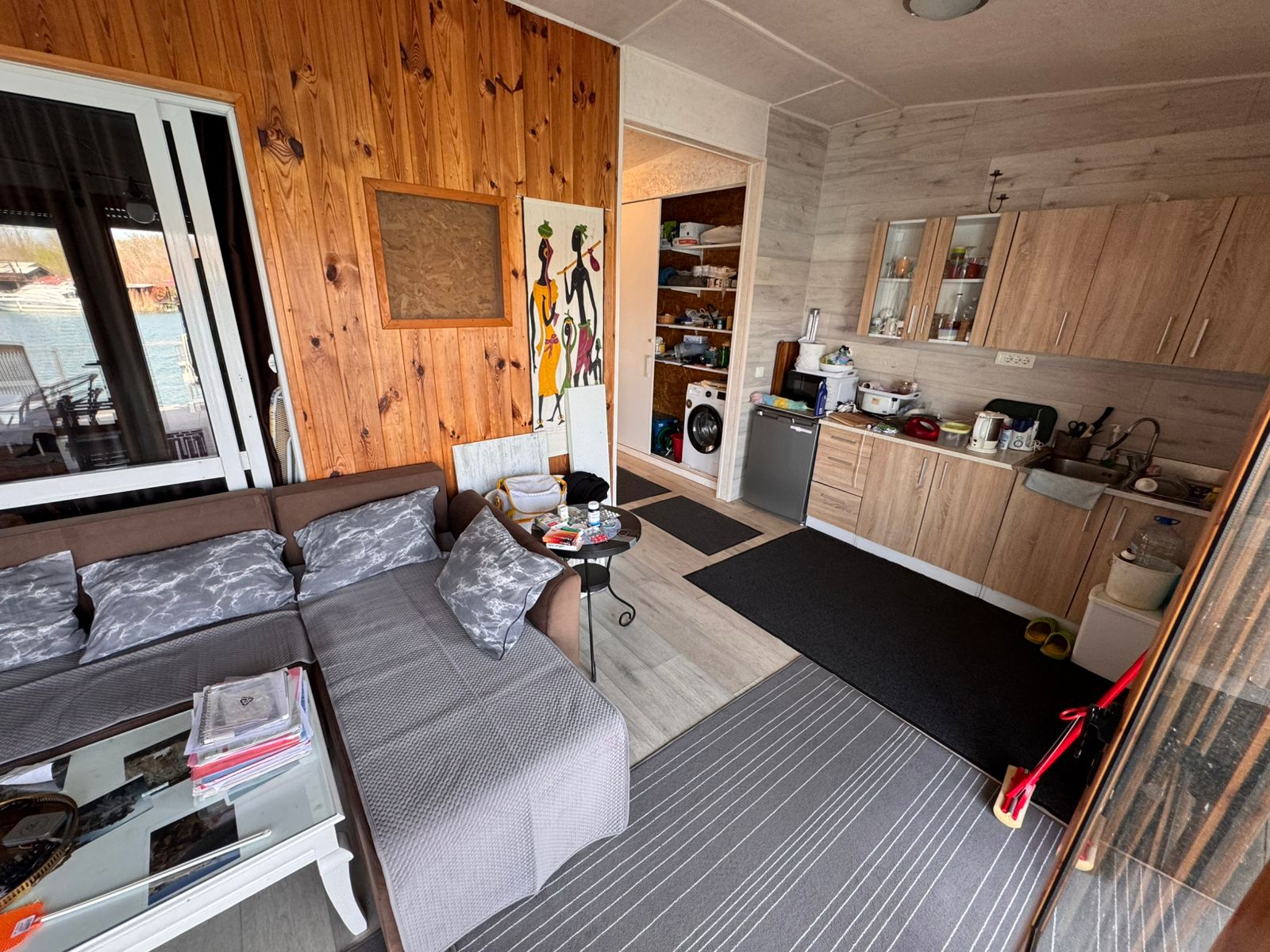 Stylish Ulcinj apartment with modern kitchen, spacious gray sectional, and wood accents&mdash;exclusive on montenegro-listings.me by ekosphere doo.