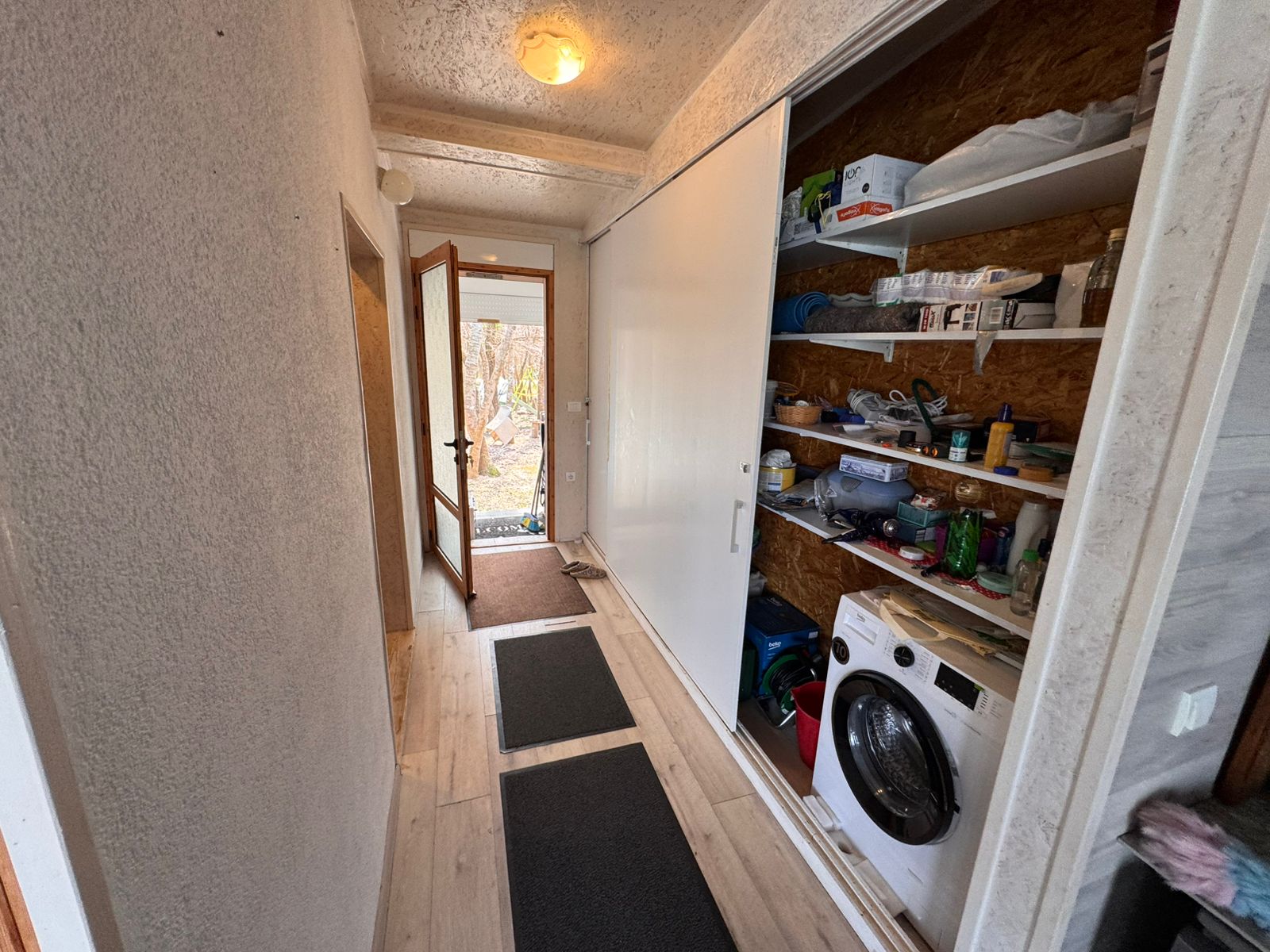 Modern hallway in Ulcinj property with wooden floors, storage closet, laundry area. Invest via montenegro-listings.me by ekosphere doo.