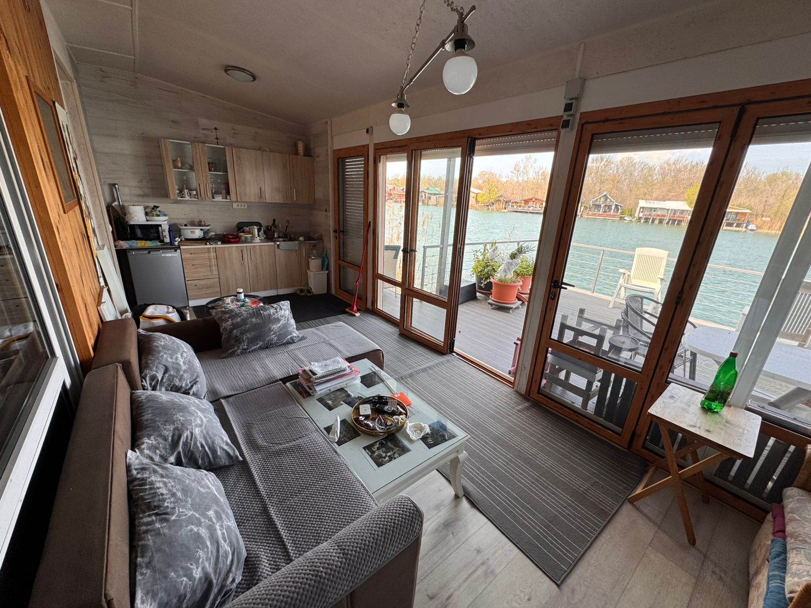 Modern riverside living in Ulcinj: bright lounge, sleek kitchen, large windows, scenic deck&mdash;exclusive at montenegro-listings.me by ekosphere doo.