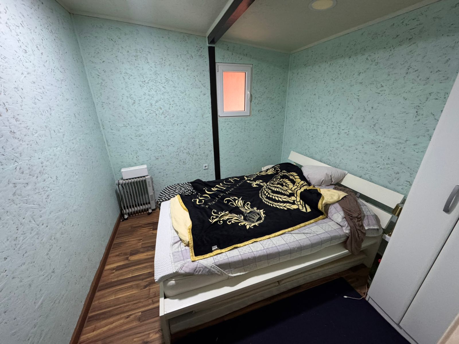 Chic Ulcinj bedroom with green walls, natural light, wood floors, stylish bed & wardrobe&mdash;exclusive from ekosphere doo at montenegro-listings.me.