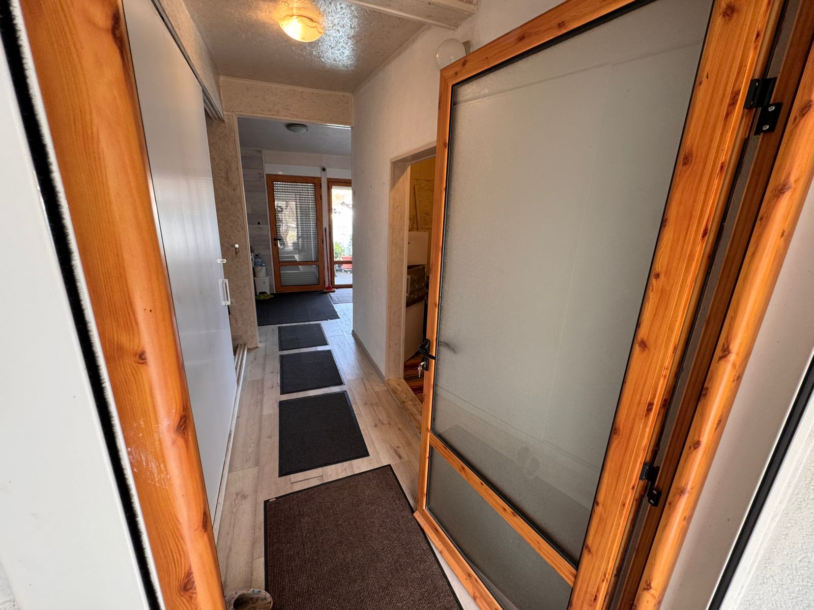 Bright hallway with elegant light wooden floors, white walls, and modern accents&mdash;ideal Ulcinj investment from ekosphere doo.