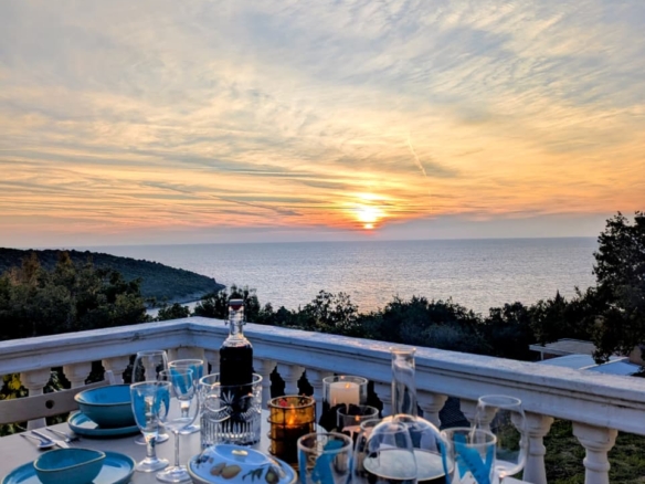 Elegant terrace in Ulcinj boasts ocean sunset views, stylish dining, and tree-lined privacy—exclusive Montenegro property by ekosphere doo.