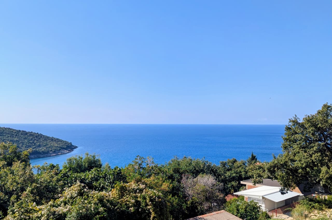 Stunning Ulcinj sea view: clear blue skies, tranquil waters, lush greenery, prime peninsula real estate&mdash;montenegro-listings.me by Ekosphere doo.