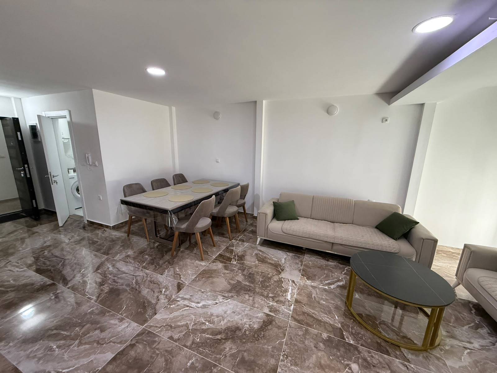 Elegant open-plan living & dining area in Ulcinj with marble floors, designer furnishings; invest via montenegro-listings.me by ekosphere doo.
