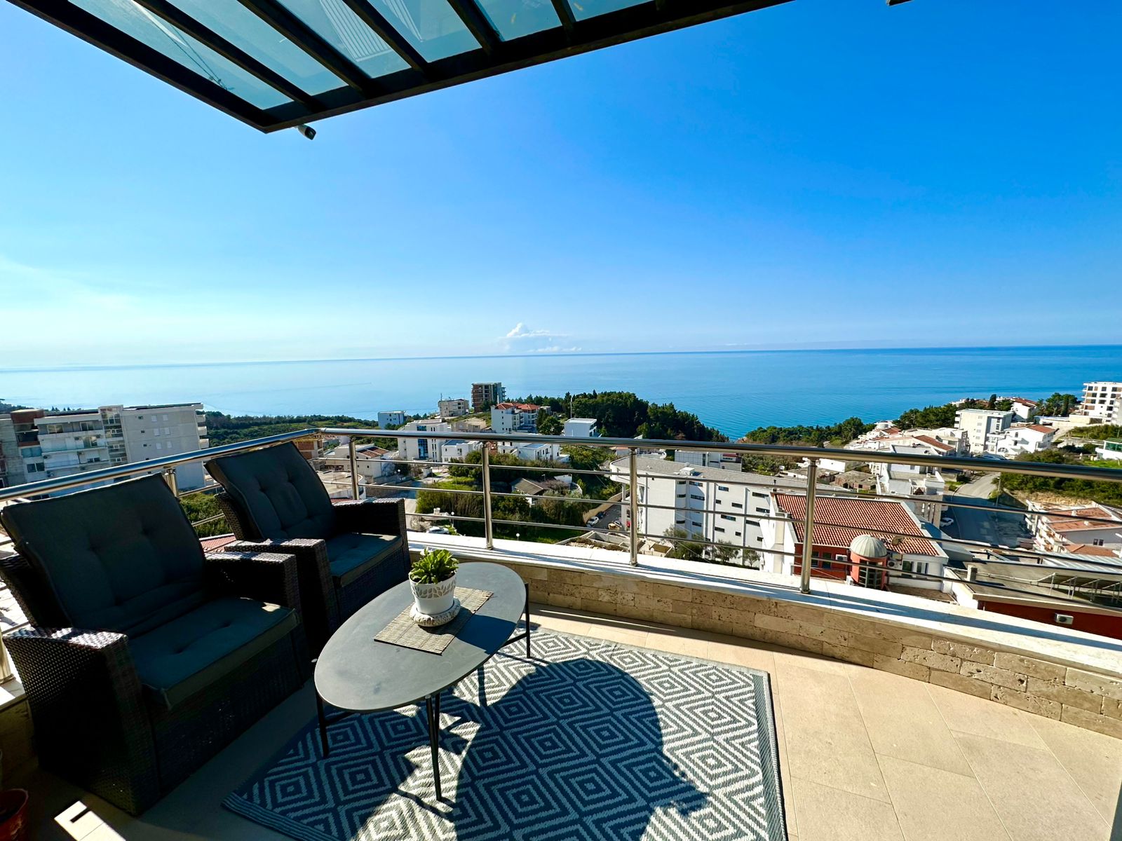Modern balcony with glass railing offers panoramic sea and city views in Ulcinj. Top investment from montenegro-listings.me by ekosphere doo.