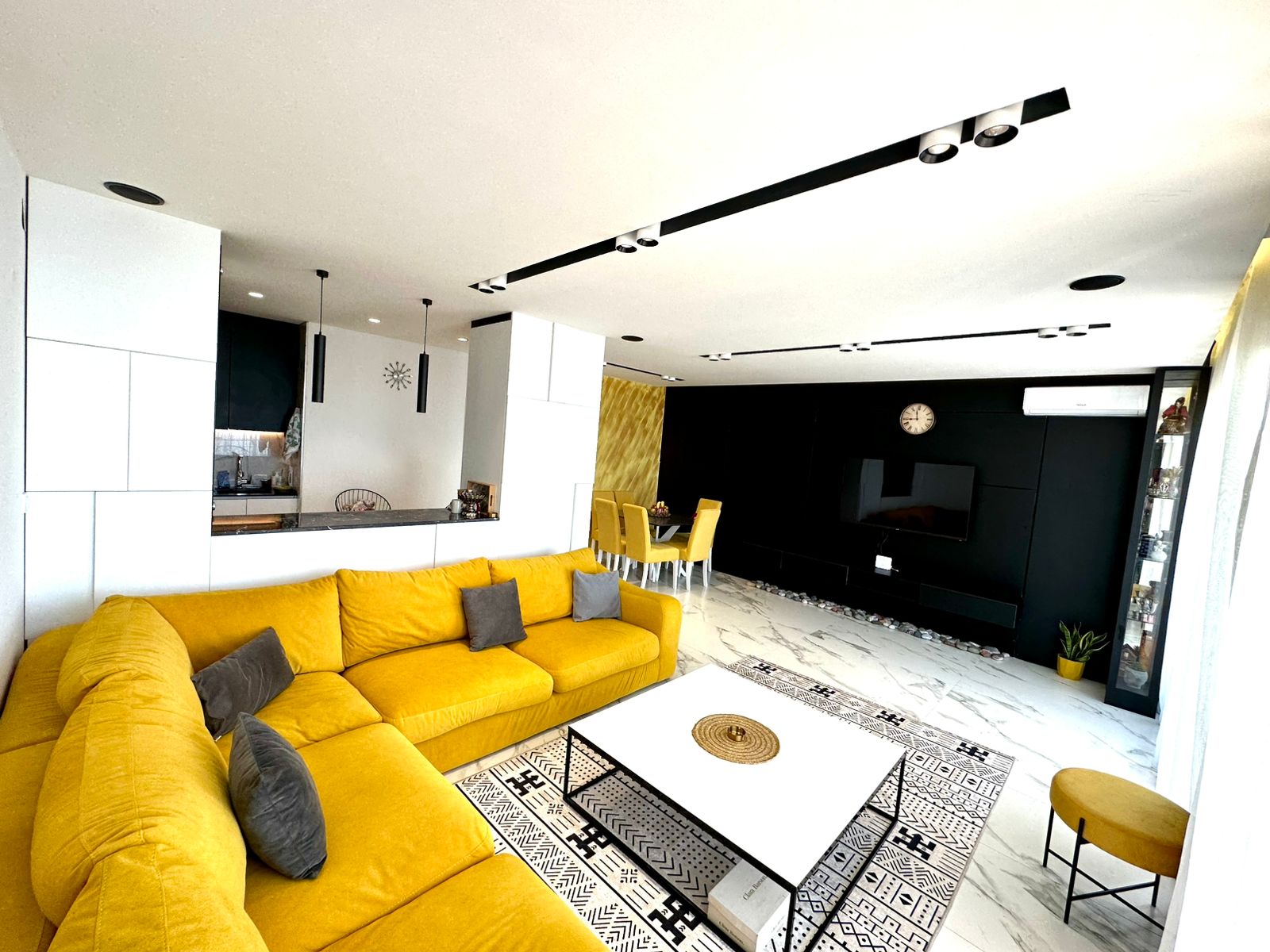 Stunning Ulcinj home with a spacious yellow sectional, chic marble floors, dining area, and designer finishes&mdash;listed on montenegro-listings.me by ekosphere doo.