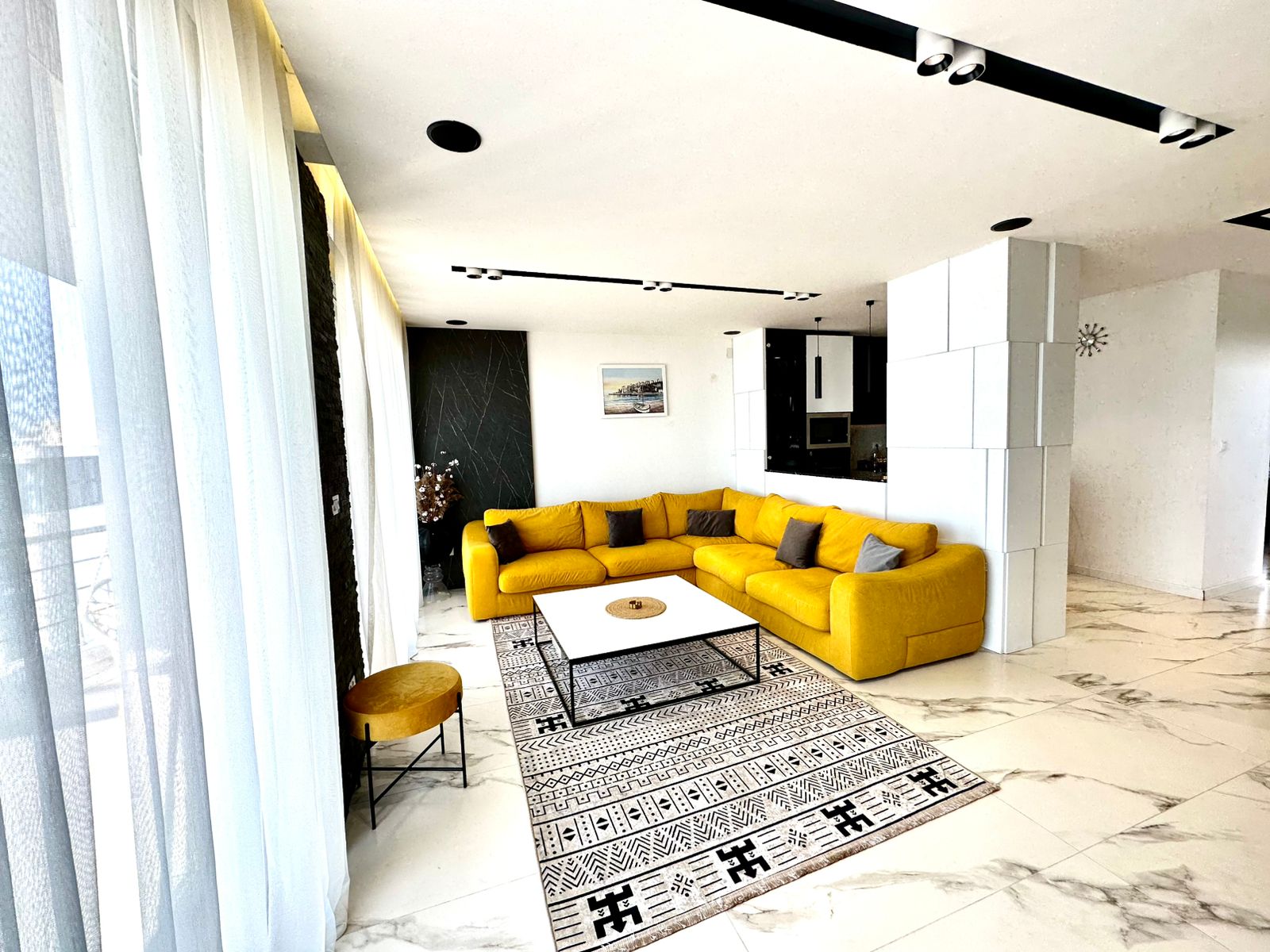 Elegant Ulcinj apartment: modern living room, yellow sectional, marble floors, floor-to-ceiling windows. Exclusive on montenegro-listings.me by ekosphere doo.