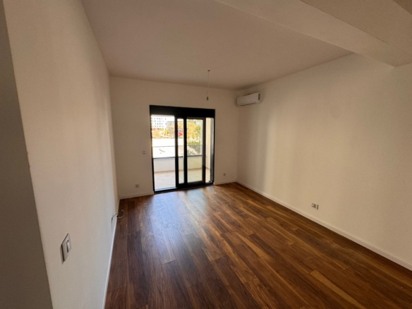 Spacious, sunlit Ulcinj apartment featuring modern dark wood flooring, AC, balcony with scenic views—ideal Montenegro investment by ekosphere doo.