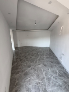 Discover exceptional investment potential in Ulcinj, Montenegro with this spacious, versatile room featuring elegant gray marble flooring and crisp white walls—ideal for customizing to your dream living or business space. The property boasts modern recessed ceiling lighting and a clean, unfinished layout ready for personal touches, including electrical fittings visible on the right wall. Perfect for investors or homeowners seeking value in the thriving Montenegro real estate market. Listed exclusively by montenegro-listings.me—a project of ekosphere doo in Ulcinj—this blank canvas offers an outstanding opportunity to secure prime property in a desirable coastal location.