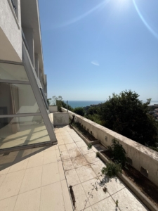 Experience premium coastal living with this spacious tiled balcony in Ulcinj, Montenegro, featuring modern glass doors and panoramic views of lush greenery and the sparkling Adriatic Sea. Enjoy sun-soaked days under clear skies while relaxing beside thoughtfully landscaped garden beds along the balcony’s edge—a perfect blend of luxury and nature. This exceptional property presents an ideal investment opportunity in the thriving Montenegro real estate market. Discover exclusive listings like this on montenegro-listings.me—a project by ekosphere doo, Ulcinj—your trusted partner for superior coastal properties.
