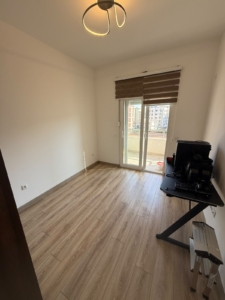 Experience potential and value in this bright, efficiently designed room featuring elegant wood flooring, pristine white walls, and modern ceiling lighting. The thoughtfully placed desk with a complete computer setup maximizes productivity, while the large window with beige blinds opens directly to a private balcony—perfect for enjoying Ulcinj’s renowned coastal ambiance. Minimalist furnishings ensure flexibility for your investment or personal touch. This inviting property is showcased by montenegro-listings.me, proudly presented by ekosphere doo Ulcinj—your trusted partner in Montenegro real estate opportunities and smart investments in the sought-after Ulcinj market.