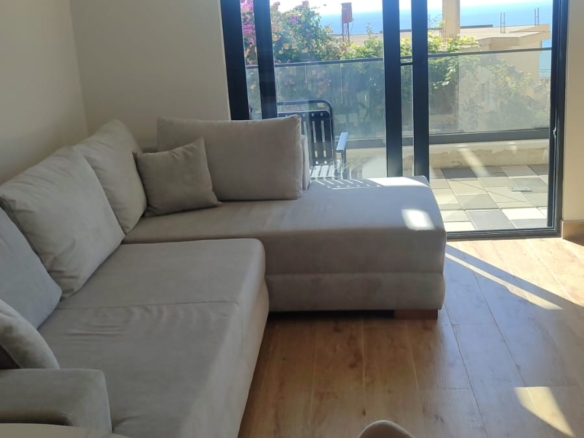 Experience modern coastal living in this stunning Ulcinj apartment, featuring a spacious and bright living room with a stylish light gray L-shaped sofa, elegant wood flooring, and a contemporary round marble dining table with chairs. Floor-to-ceiling glass doors seamlessly open to a private balcony boasting breathtaking sea views—perfect for relaxation or entertaining. This premium property is an exceptional real estate investment opportunity in Montenegro’s sought-after Ulcinj region. Discover more exclusive listings like this at montenegro-listings.me—a trusted project of ekosphere doo in Ulcinj—offering you the best in Montenegrin coastal real estate.