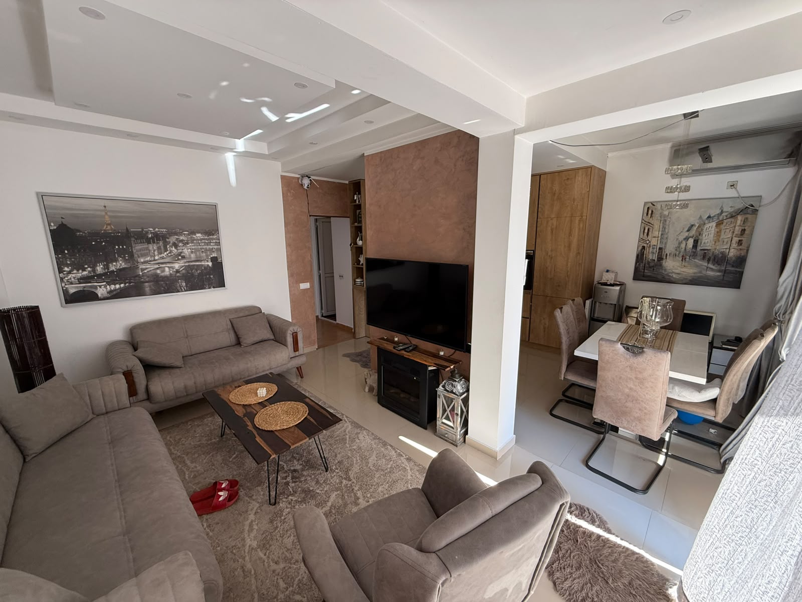 Discover this elegantly designed modern living and dining space in Ulcinj, Montenegro—perfect for property investors seeking a stylish retreat or lucrative rental opportunity. This inviting open-plan area features two contemporary sofas, a comfortable armchair, a sleek TV on a stand, a chic coffee table, and a designer rug—all set in sophisticated neutral tones that exude luxury and comfort. The adjacent dining area includes a spacious table with six chairs and tasteful wall art, creating an ideal setting for entertaining family or guests. Explore exclusive investment options like this stunning home only on montenegro-listings.me—a project of ekosphere doo based in Ulcinj—to secure prime real estate in Montenegro’s thriving market.